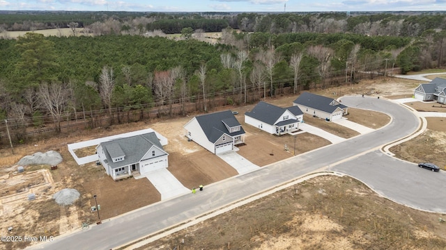 drone / aerial view featuring a view of trees