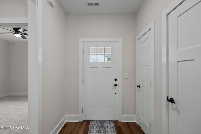 entryway with a ceiling fan, baseboards, visible vents, and dark wood-style flooring