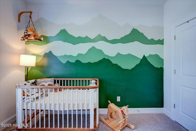 bedroom with a crib, baseboards, and carpet floors