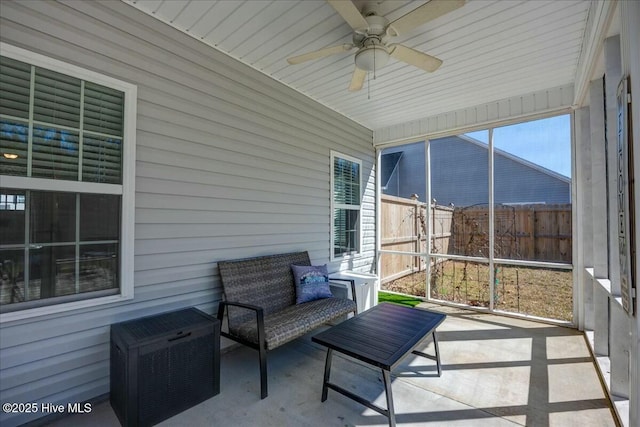 sunroom / solarium with a ceiling fan