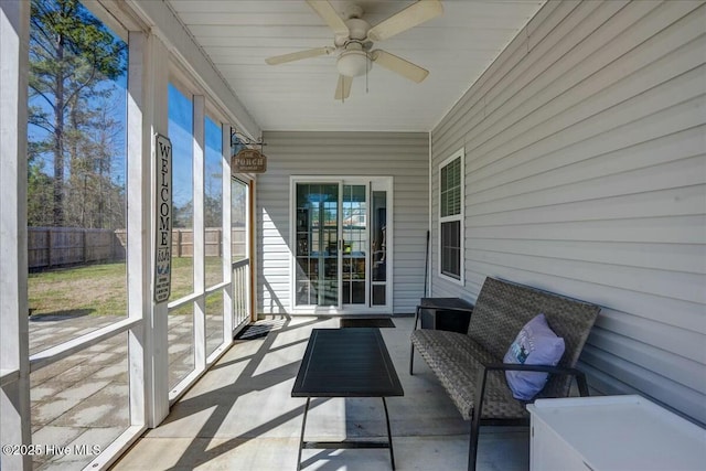 unfurnished sunroom featuring ceiling fan