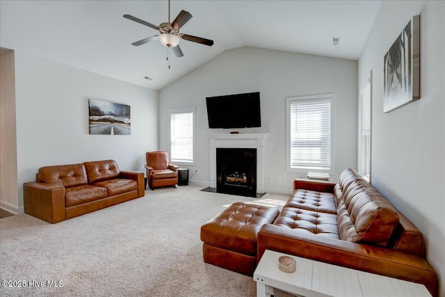 carpeted living room with visible vents, baseboards, a fireplace with flush hearth, lofted ceiling, and a ceiling fan