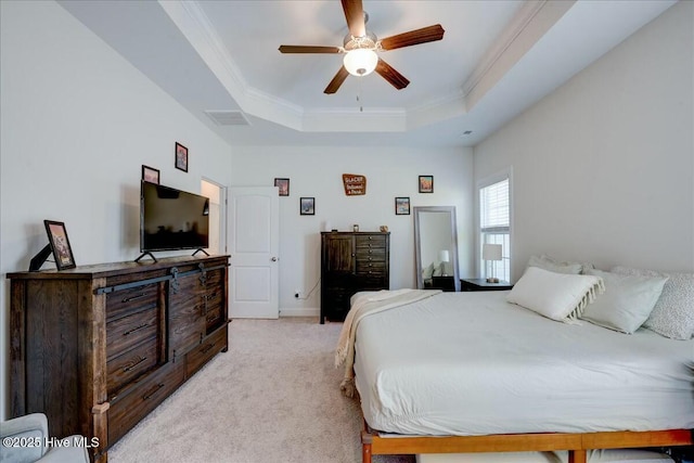 bedroom with visible vents, ornamental molding, baseboards, a raised ceiling, and light colored carpet