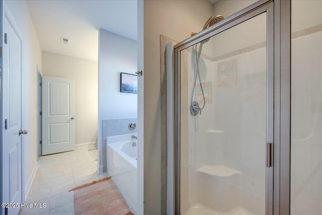 bathroom featuring tile patterned floors, visible vents, a garden tub, a stall shower, and baseboards