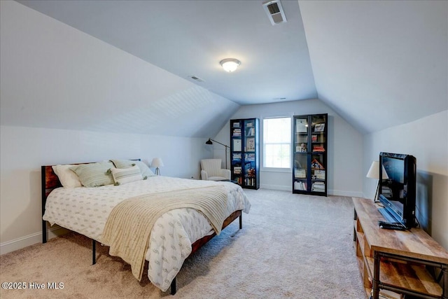 bedroom with visible vents, light colored carpet, lofted ceiling, and baseboards