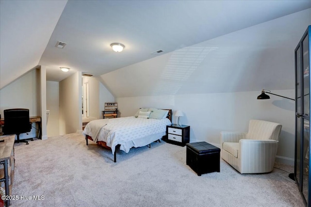 carpeted bedroom featuring vaulted ceiling, baseboards, and visible vents