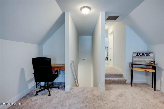 office featuring vaulted ceiling, carpet, visible vents, and baseboards