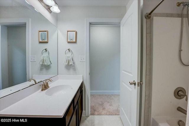 bathroom with baseboards, vanity, and  shower combination