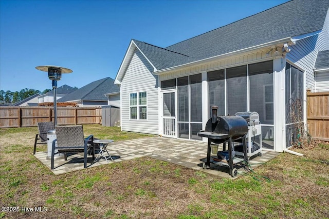 back of house featuring a patio area, a lawn, and a fenced backyard