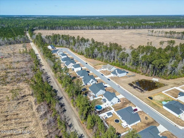 birds eye view of property with a forest view