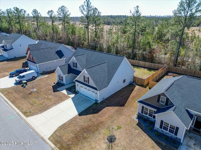 bird's eye view with a wooded view