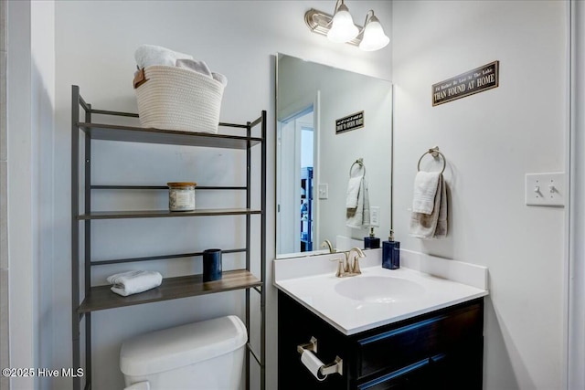 bathroom with toilet and vanity