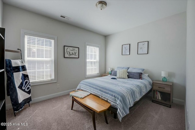 carpeted bedroom featuring visible vents and baseboards