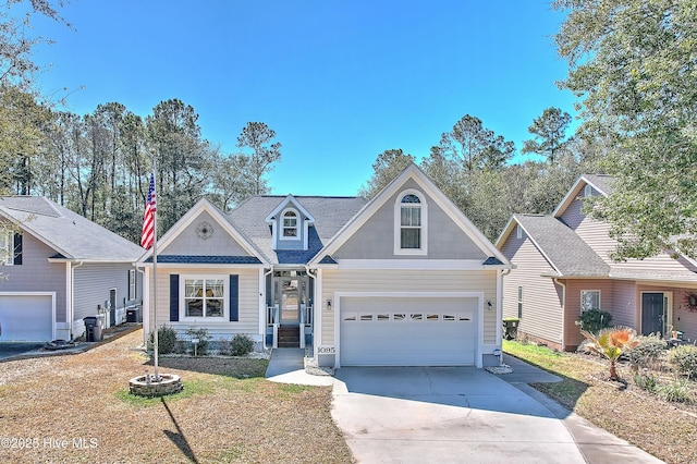 traditional-style house with concrete driveway, a garage, and roof with shingles