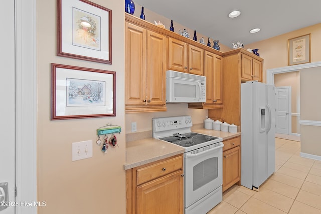 kitchen with recessed lighting, white appliances, light countertops, light tile patterned floors, and baseboards