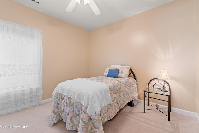 bedroom featuring a ceiling fan, carpet, and baseboards