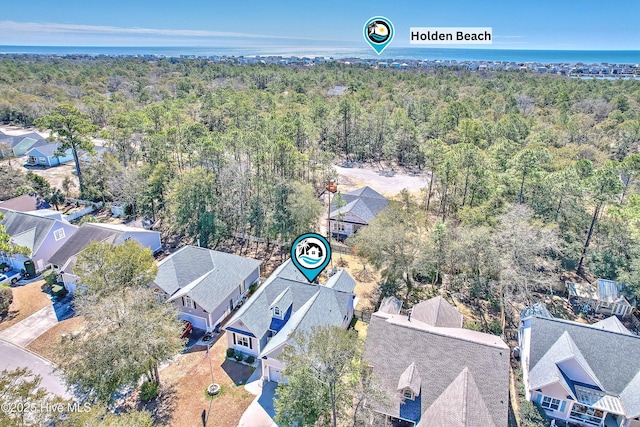 drone / aerial view with a residential view and a wooded view