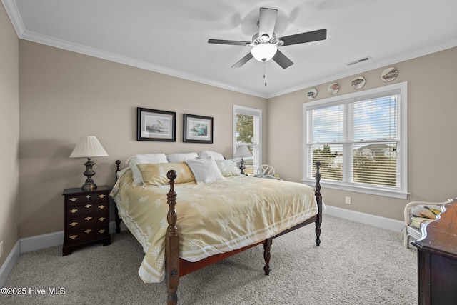 carpeted bedroom with ceiling fan, visible vents, baseboards, and ornamental molding