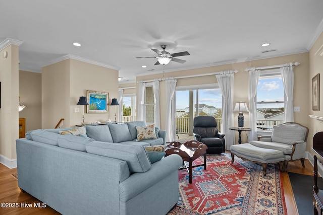 living area with visible vents, crown molding, baseboards, recessed lighting, and wood finished floors