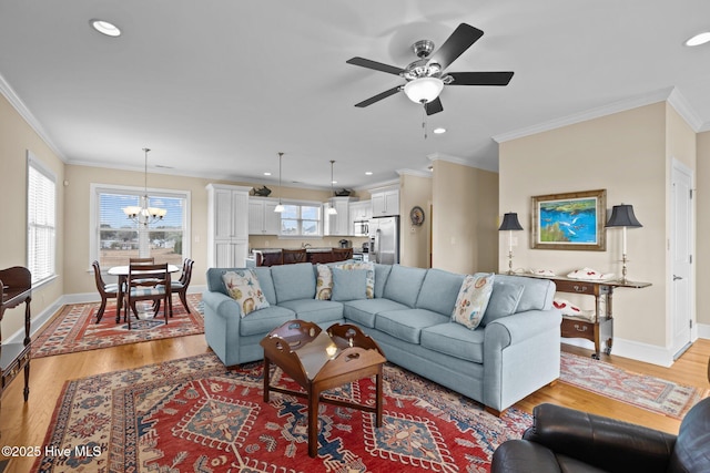 living area with light wood finished floors, crown molding, and baseboards