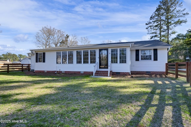 back of house featuring crawl space, a fenced backyard, entry steps, and a yard