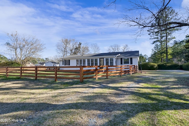 view of front facade with a front yard and fence