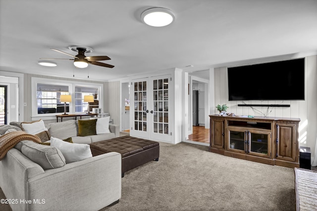 living room with french doors, carpet, and a ceiling fan