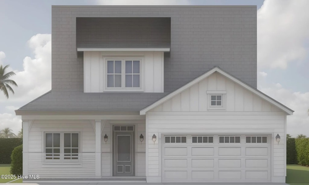 view of front of house with board and batten siding, an attached garage, and driveway