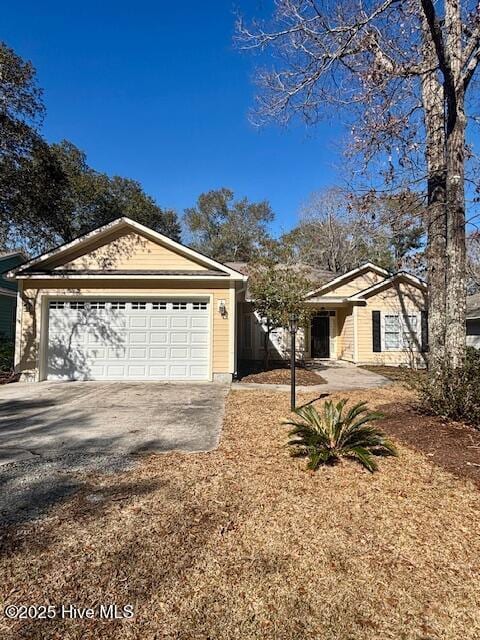 single story home with driveway and an attached garage