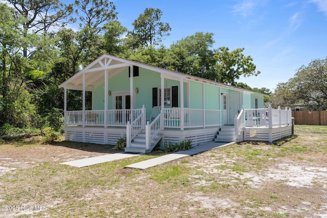 109 NE 17th St, Oak Island, NC 28465 - view of front facade with a porch