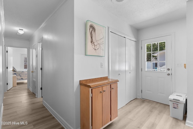 109 NE 17th St, Oak Island, NC 28465 - corridor with light wood-style flooring, a textured ceiling, and crown molding