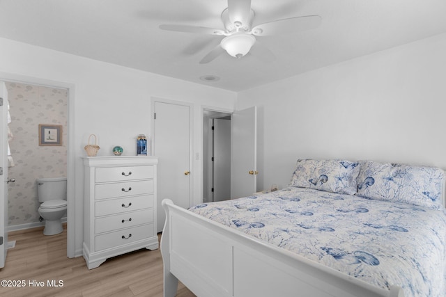 109 NE 17th St, Oak Island, NC 28465 - bedroom with light wood-type flooring, ensuite bath, ceiling fan, and baseboards