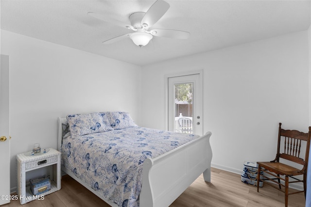 109 NE 17th St, Oak Island, NC 28465 - bedroom featuring access to outside, wood finished floors, and a ceiling fan