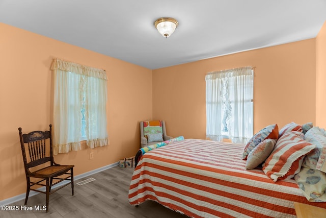 109 NE 17th St, Oak Island, NC 28465 - bedroom with wood finished floors and baseboards