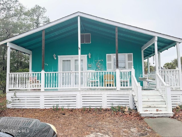 rear view of house with central AC and a porch