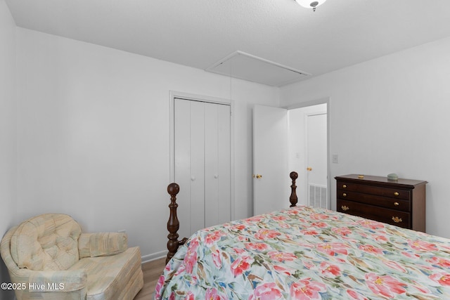 109 NE 17th St, Oak Island, NC 28465 - bedroom featuring attic access, wood finished floors, a closet, and baseboards