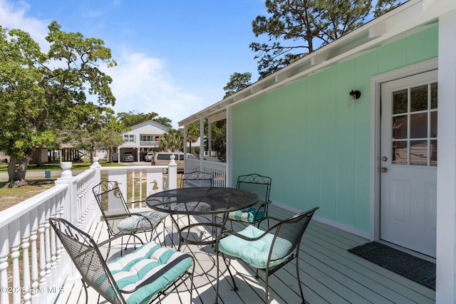 109 NE 17th St, Oak Island, NC 28465 - wooden deck featuring outdoor dining area
