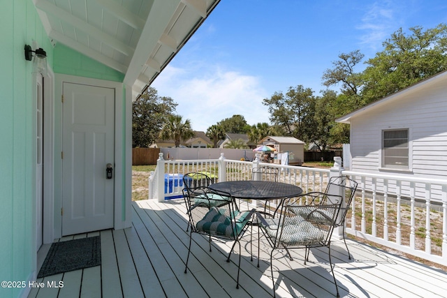 109 NE 17th St, Oak Island, NC 28465 - deck featuring outdoor dining space and a fenced backyard