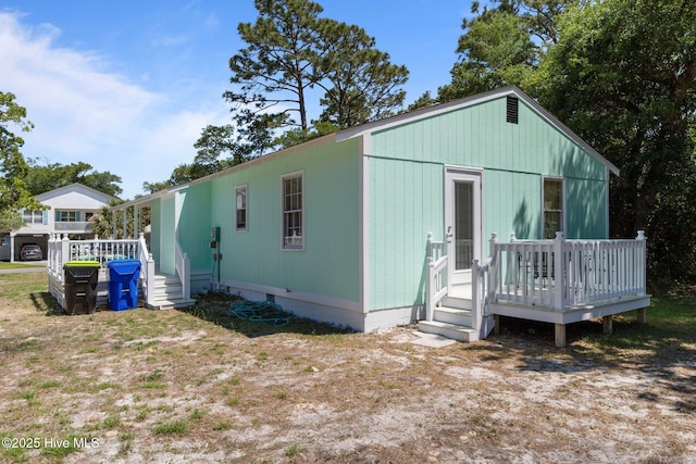 109 NE 17th St, Oak Island, NC 28465 - view of side of property with a deck and crawl space