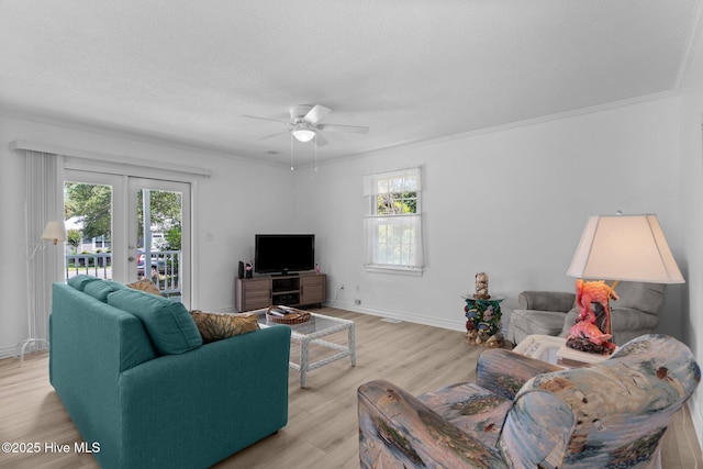 109 NE 17th St, Oak Island, NC 28465 - living room with healthy amount of natural light, a ceiling fan, light wood-type flooring, french doors, and crown molding
