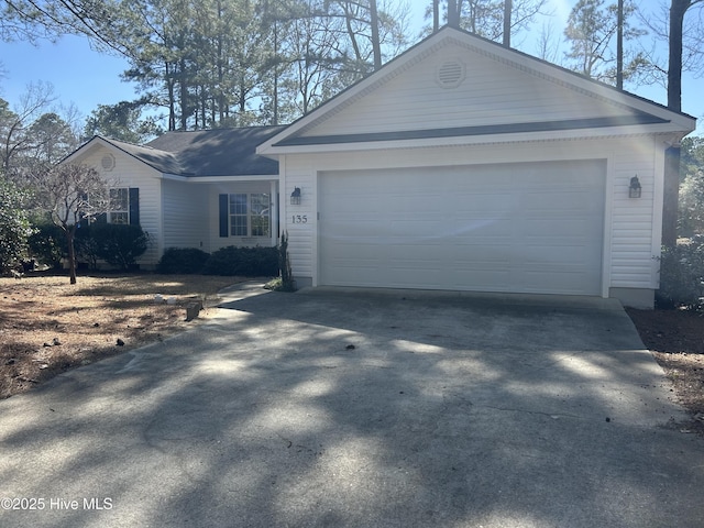 ranch-style home with an attached garage and driveway