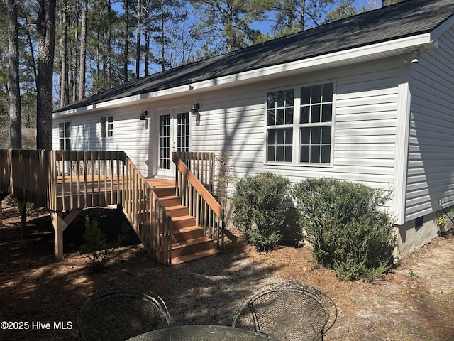 exterior space with a deck, french doors, and crawl space