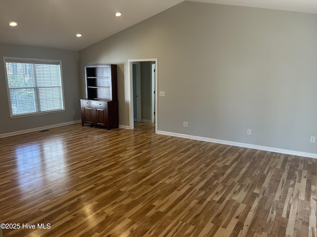 interior space with baseboards, visible vents, high vaulted ceiling, recessed lighting, and dark wood-type flooring