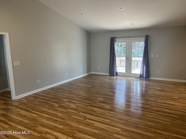 spare room with recessed lighting, dark wood-type flooring, and baseboards