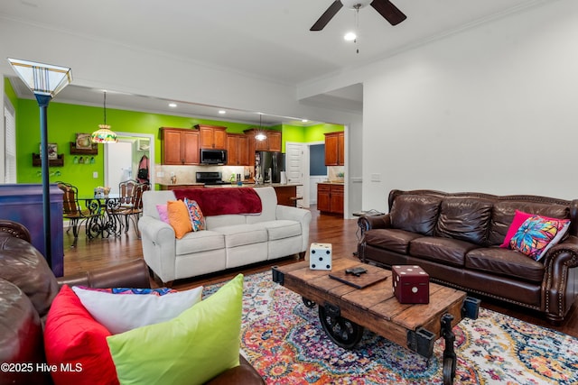 living room with recessed lighting, wood finished floors, and ornamental molding