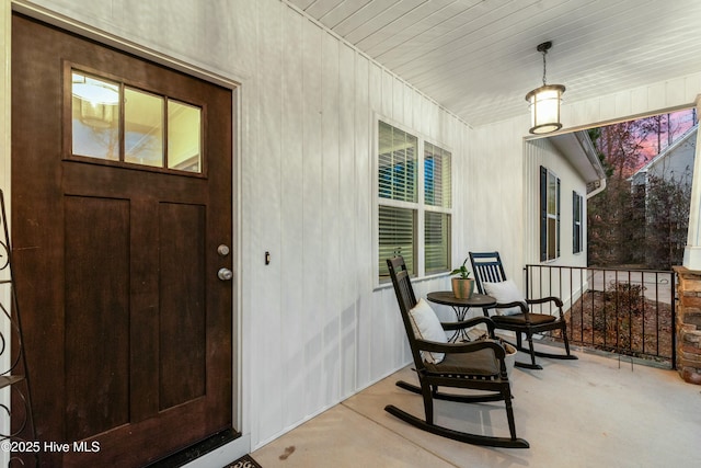 view of exterior entry featuring a porch