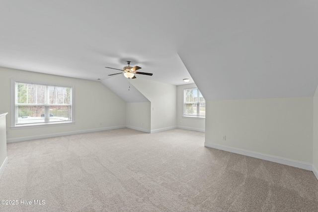 bonus room with light colored carpet, lofted ceiling, baseboards, and ceiling fan