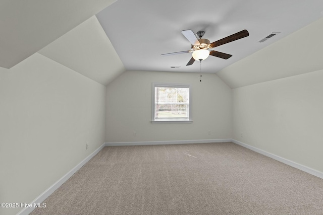 bonus room with visible vents, baseboards, light colored carpet, and lofted ceiling