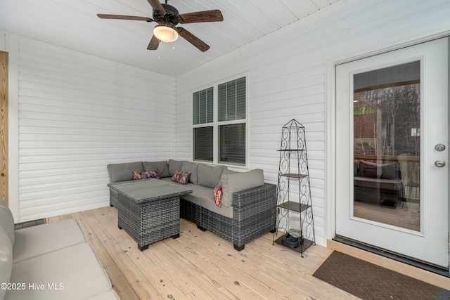 deck featuring outdoor lounge area and a ceiling fan