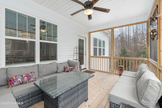 sunroom / solarium with a ceiling fan